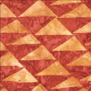 May include: A fabric pattern featuring a repeating geometric design of triangles in shades of golden yellow and deep red. The surface displays a mottled, batik-style texture with variations in color intensity across the triangular shapes.