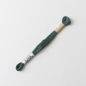 May include: A skein of green embroidery floss with a label that reads "COSMO 536A".