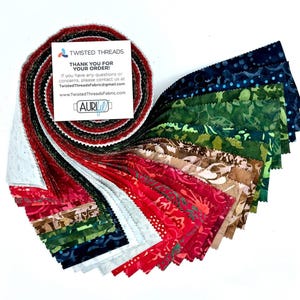May include: A jelly roll of fabric strips featuring a variety of batik patterns in shades of red, green, brown, and blue. A white square card is placed on top with the text TWISTED THREADS THANK YOU FOR YOUR ORDER and contact information.