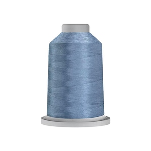 May include: A spool of thread in a dusty blue color with a subtle sheen. The thread is wound tightly around a cylindrical core, featuring a flat top and a wider base. The surface of the thread shows a smooth, consistent texture throughout the spool.