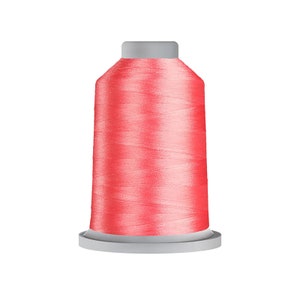 May include: A spool of bright pink thread for sewing or embroidery.