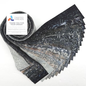 May include: A jelly roll of fabric strips featuring various shades of black, gray, and charcoal with batik-style patterns. A white square card is attached to the roll with the text TWISTED THREADS THANK YOU FOR YOUR ORDER and contact details.