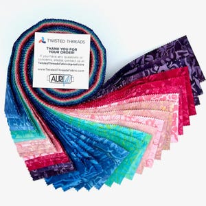 May include: A jelly roll of batik fabric strips featuring a gradient of colors from deep purple and magenta to pink, peach, light blue, and teal. A white card with the text TWISTED THREADS THANK YOU FOR YOUR ORDER and AURIfil is attached.