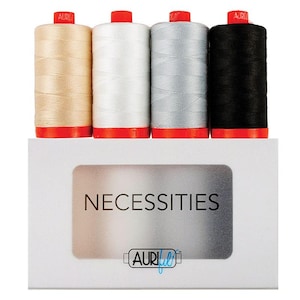 May include: A set of four spools of thread in beige, white, grey, and black, each with a red top and base. The spools are displayed above a white rectangular box featuring the text NECESSITIES and the Aurifil logo in a central window.