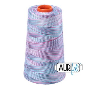 May include: A large conical spool of sewing thread featuring a variegated pattern of light blue, white, and magenta pink stripes. The top of the spool has an orange plastic core, and the logo AuriFil is printed in black and blue on the lower right.