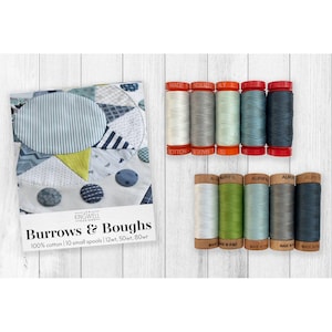 May include: A set of ten small spools of 100% cotton thread by Aurifil, labeled Burrows & Boughs, featuring a color palette of white, gray, green, and blue tones. The spools are arranged in two rows of five, accompanied by a product card.