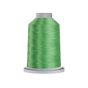 May include: A spool of bright green thread for sewing or embroidery.