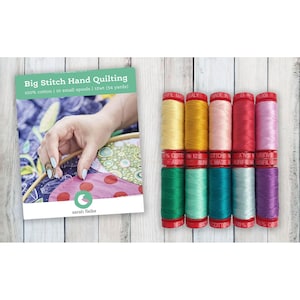 May include: A collection of colorful quilting thread spools with a book titled "Big Stitch Hand Quilting." The book cover features a hand quilting project. The thread spools are in various colors, including yellow, pink, red, and purple.
