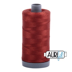May include: A spool of red thread with the brand name "Aurifil" printed on the side.
