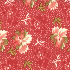 May include: Close-up of a red fabric with a floral pattern. The design features large, stylized flowers in shades of red and pink, with green leaves and white accents. The background is a dotted pattern.