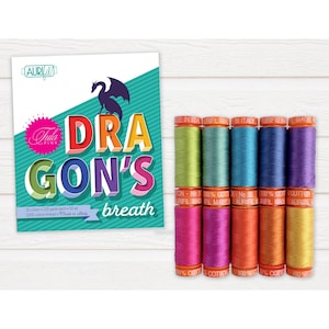 May include: A set of 10 spools of cotton thread in various shades of green, blue, purple, orange, and yellow. The thread is labeled "Aurifil" and is made in Italy. The thread is part of a collection called "Tula Pink Dragon's Breath".
