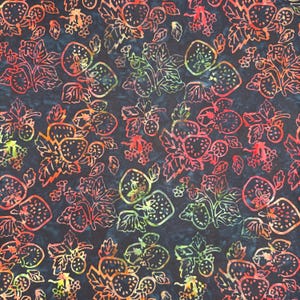 May include: A dark navy blue fabric featuring a repeating batik-style pattern of strawberries and leaves. The fruit and foliage are outlined in vibrant gradients of red, orange, yellow, and lime green, creating a high-contrast botanical design.