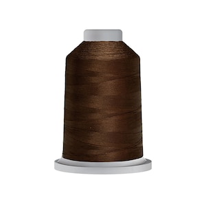May include: A spool of brown thread for sewing or embroidery.