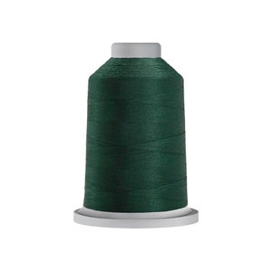 May include: A spool of dark green thread.