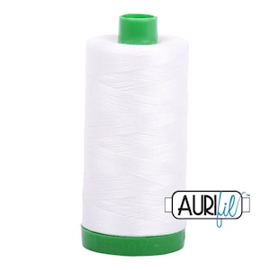 May include: A spool of white sewing thread with a bright green plastic top and base. The spool features a cylindrical shape with the brand name AuriFil printed in a black and blue logo on the lower right side of the white thread surface.
