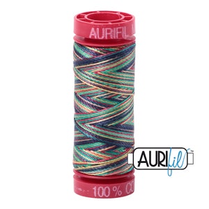 May include: A spool of Aurifil 100% cotton thread in a multi-colored variegated pattern. The thread is wound around a red plastic spool with the Aurifil logo printed on it.