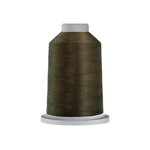 May include: A spool of dark green thread.