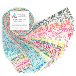 May include: A jelly roll of fabric strips featuring a variety of batik patterns in shades of blue, pink, yellow, and green. A square white card is attached to the top, displaying the text TWISTED THREADS THANK YOU FOR YOUR ORDER.