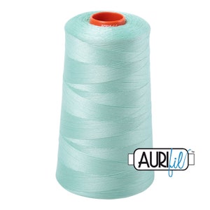 May include: A spool of light blue thread with the brand name "AURIfil" printed on the side.