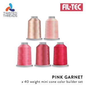 May include: A set of six mini cones of 40 weight embroidery thread in shades of pink, from light to dark, labeled "Pink Garnet" and "a 40 weight mini cone color builder set". The thread is made by Fil-Tec and Twisted Threads.