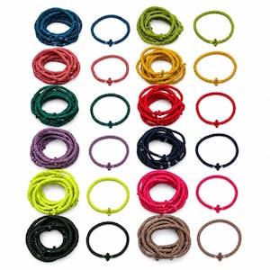 May include: A collection of twenty-four beaded bracelets arranged in a grid. Twelve bracelets are coiled into multi-layered circles, and twelve are single-strand loops. The beads come in various colours including blue, red, green, purple, yellow, and brown.