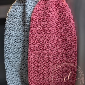 May include: Two crocheted dishcloths with wooden buttons. One cloth is grey and the other is red.