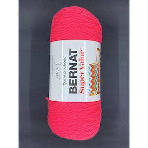 May include: A skein of pink yarn labeled "Bernat Super Value" yarn inspirations, 7 oz/197 g.