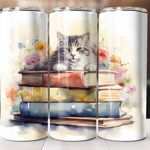 May include: A watercolor illustration of a gray and white cat sitting on a stack of colorful books. The cat is looking to the left and the books are surrounded by watercolor flowers.
