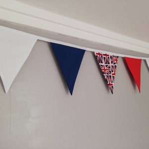 May include: A bunting with alternating white, blue, red, and Union Jack patterned triangular flags.