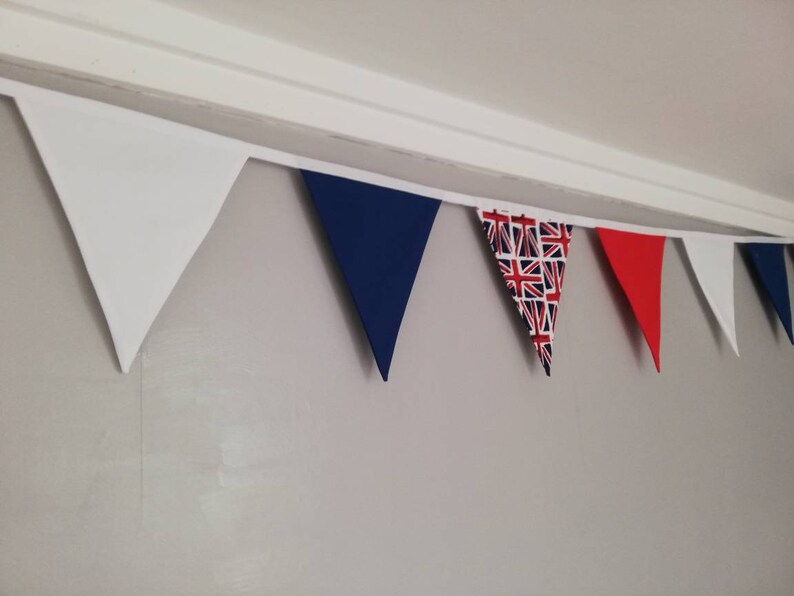 May include: A bunting with alternating white, blue, red, and Union Jack patterned triangular flags.