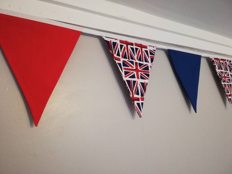May include: A bunting with red, white and blue triangular flags. The flags have a Union Jack pattern.