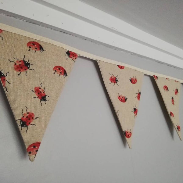 Ladybird fabric bunting, natural background with red and black print, 10 flags, approx 2.5 metres