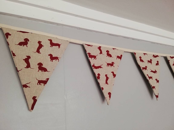 Sausage dog bunting ! Dark red dogs in a variety of poses on a natural background fabric. #sausagedoggifts #sausagedog