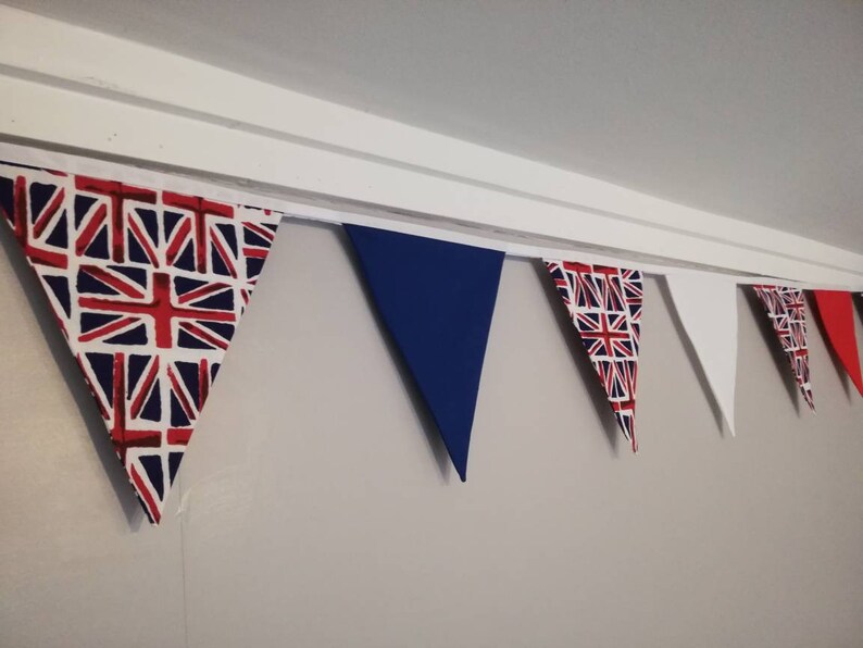 May include: A bunting with alternating flags in red, white, and blue, with a Union Jack pattern on the first flag.