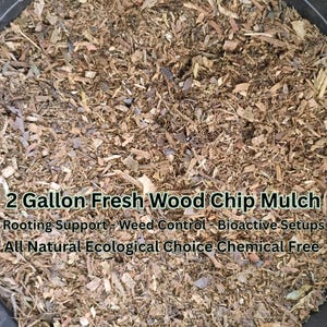 May include: Close-up of fresh wood chip mulch. The text reads: "2 Gallon Fresh Wood Chip Mulch. Rooting Support - Weed Control - Bioactive Setups. All Natural Ecological Choice Chemical Free."