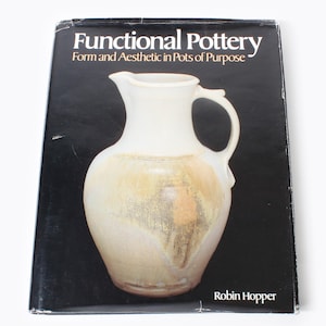 May include: A book titled "Functional Pottery: Form and Aesthetic in Pots of Purpose" by Robin Hopper. The cover features a close-up of a white ceramic pitcher with a brown and yellow glaze.