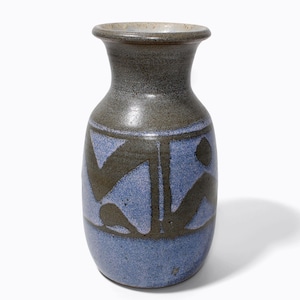 May include: A ceramic vase with a blue and brown colour scheme. The vase has a rounded body and a narrow neck. The blue section features a dark brown abstract design. The vase is approximately 18 cm tall.