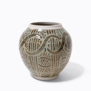 May include: A ceramic vase with a light green glaze and a brown, swirling pattern.