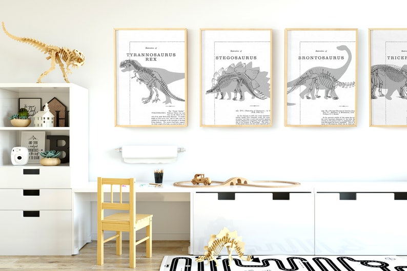 May include: Four framed dinosaur prints with scientific illustrations, including a Tyrannosaurus Rex, Stegosaurus, Brontosaurus, and Triceratops. A wooden dinosaur skeleton and a toy train set are also visible.