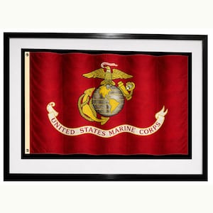 May include: Framed red flag featuring the United States Marine Corps emblem. The emblem shows a golden eagle above a globe, with an anchor and the words "United States Marine Corps" on a white banner.