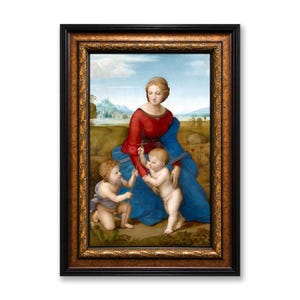 May include: A framed print of a Renaissance painting. The artwork depicts a woman in a red dress and blue cloak with two cherubic children. The frame is black with gold accents. The background shows a landscape with a blue sky.