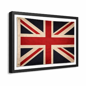 May include: A white ceramic mug with a black handle and the text "But First, Coffee" in a bold, black font. The mug is set against a blurred background, suggesting a cozy setting.