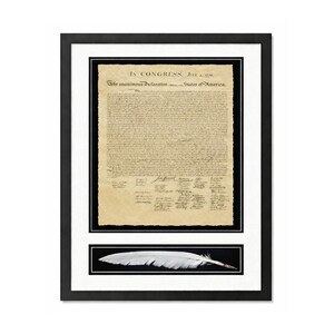 May include: Framed print of the Declaration of Independence with a white feather at the bottom. The document is on aged paper with black text. The frame is black with a white mat.