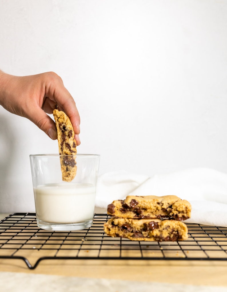 Vegan Gluten Free Chocolate Chip Cookie Being Dunked in Milk