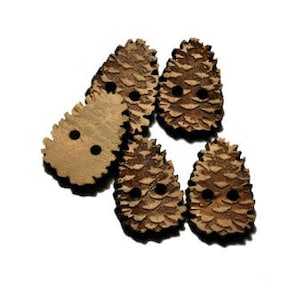 May include: Five brown wooden buttons shaped like pine cones. Each button has two holes for sewing.