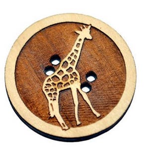 May include: A wooden button with a giraffe design. The button is brown with a light brown border. The giraffe is white and has a brown pattern.