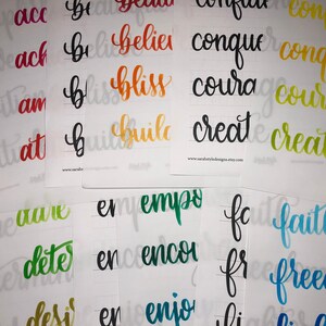 May include: A set of 10 cards with hand-lettered words in various colors, including red, orange, yellow, green, blue, and black. The words are: "accomplish", "achieve", "ambition", "attitude", "believe", "bliss", "build", "conquer", "courage", "create", "dare", "determine", "desire", "empower", "encourage", "enjoy", "faith", "freedom", "give", "grow", "happy", "heal", "hope", "inspire", "joy", "kindness", "love", "magic", "miracle", "motivate", "peace", "positive", "powerful", "pray", "purpose", "resilience", "smile", "strength", "thankful", "trust", "understand", "wisdom", "worthy", "you".