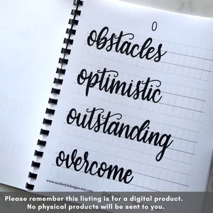 May include: A notebook with a spiral binding and lined pages. The notebook has a black ink inscription of the words "obstacles", "optimistic", "outstanding", and "overcome" on the pages. The words are written in a cursive font.
