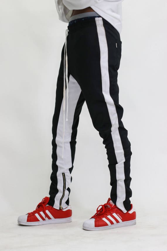 black track pants with red and white stripe