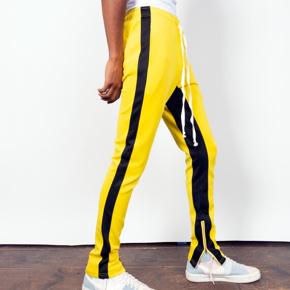 yellow track pants with black stripe